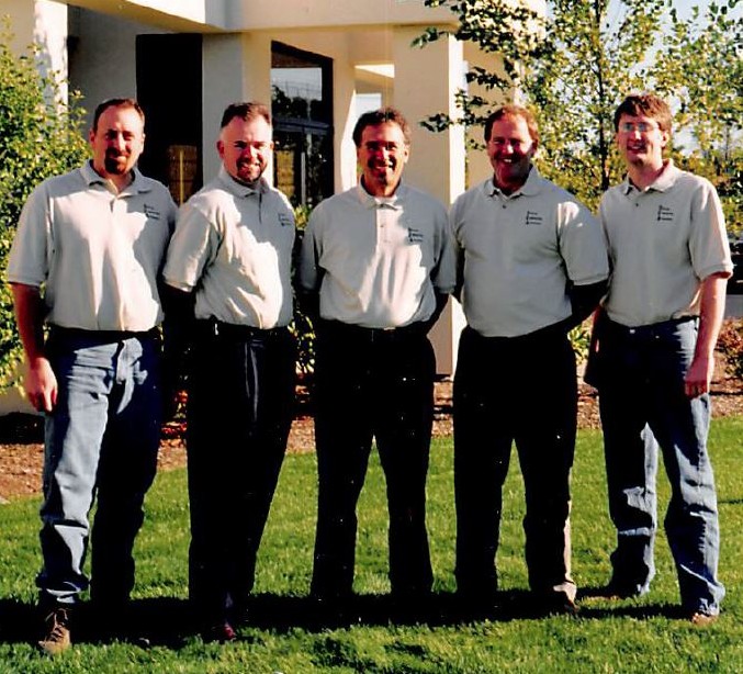 Chris stands with his DiPrete colleagues in the mid 2000’s